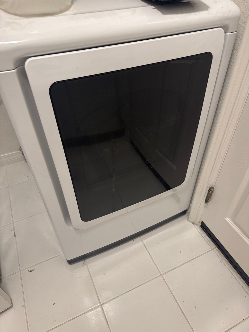 Front-loading dryer installed neatly in a compact laundry space