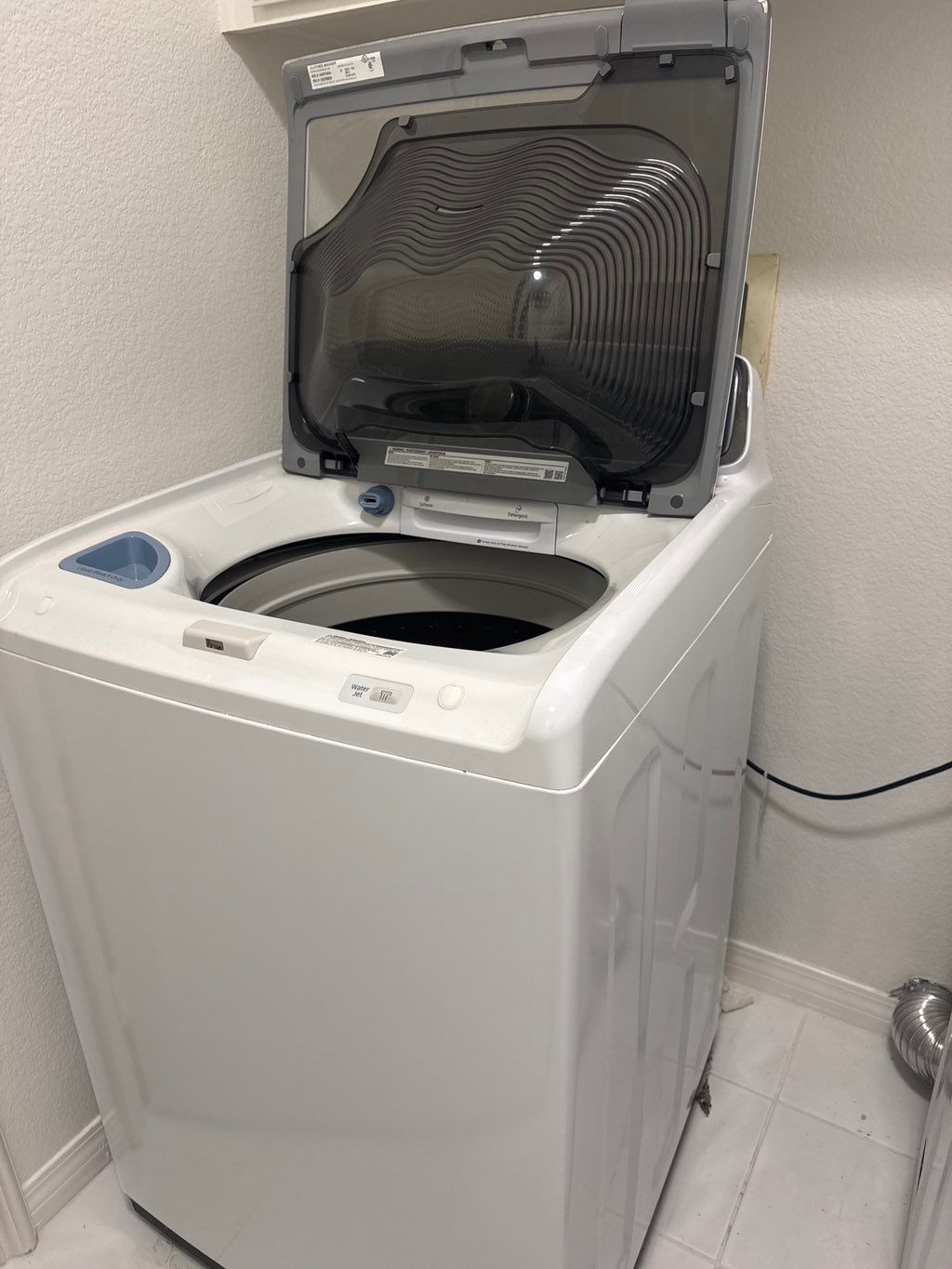 Top-loading washer installed beside the matching dryer